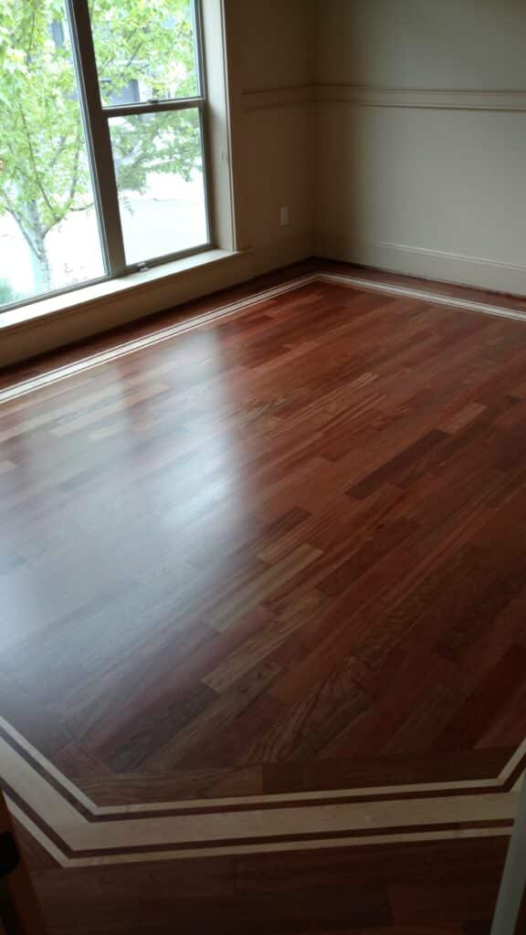 Exotic Brazilian Cherry wood floor with custom light wood inlay border