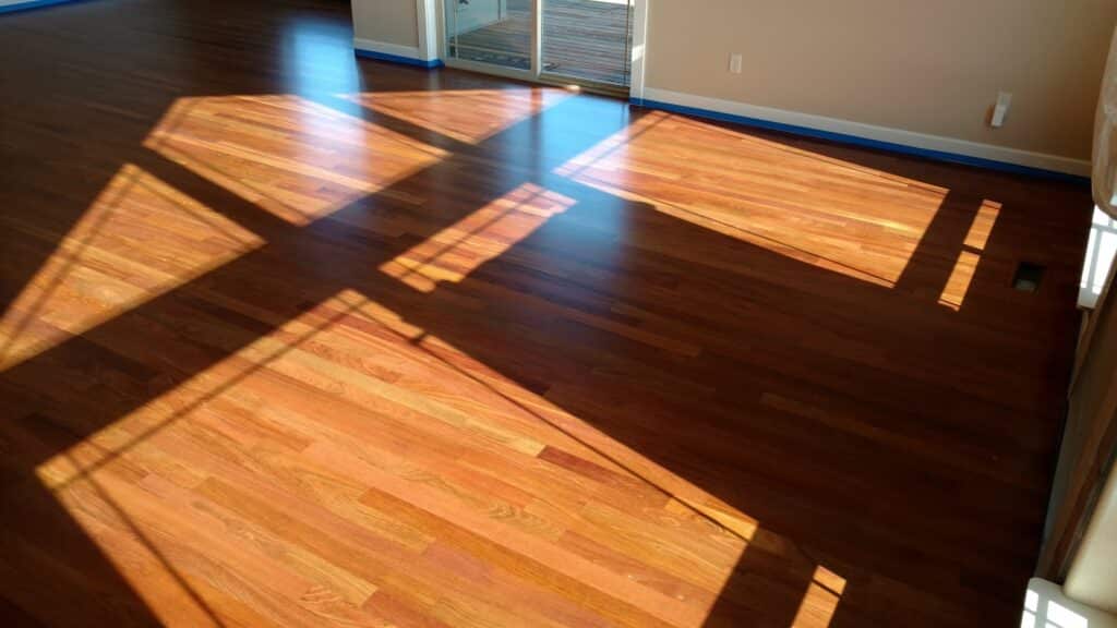 Deep red Jatoba floor planks showing natural wood grain in sunlight